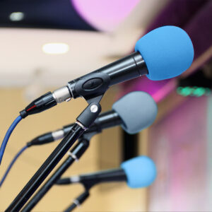 Blue microphones on the main stage at a public speaking gig found with My Speaker Leads Image courtesy Lusma Trading