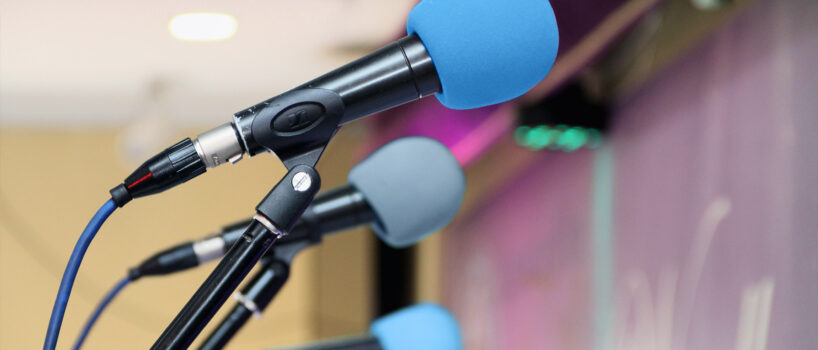Getting speaking engagements sponsored - like this one with several blue microphones